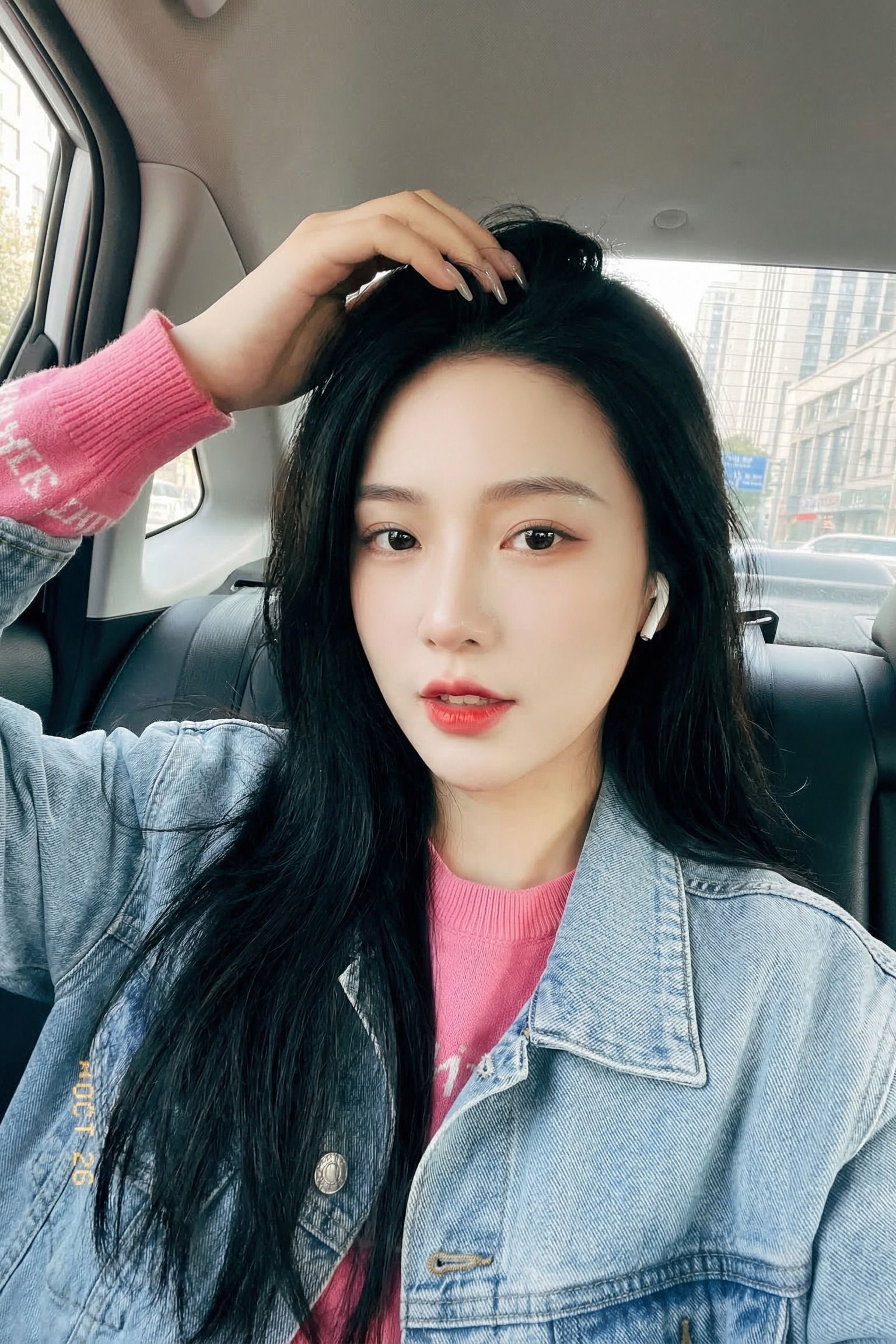 Close-Up Portrait Selfie With Hand in Hair and Denim Jacket