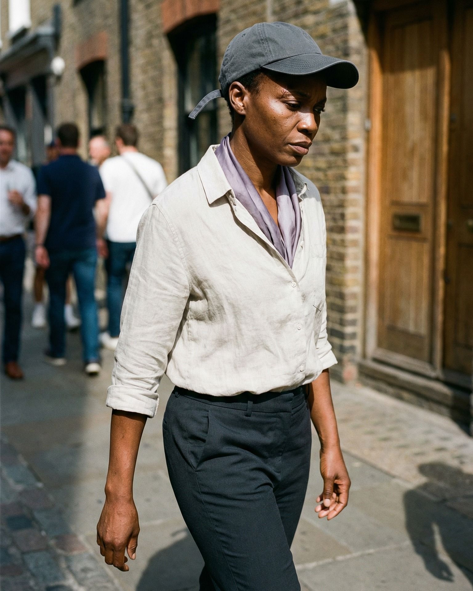 Woman Walking in Harsh Sunlight, Focused and Unhurried