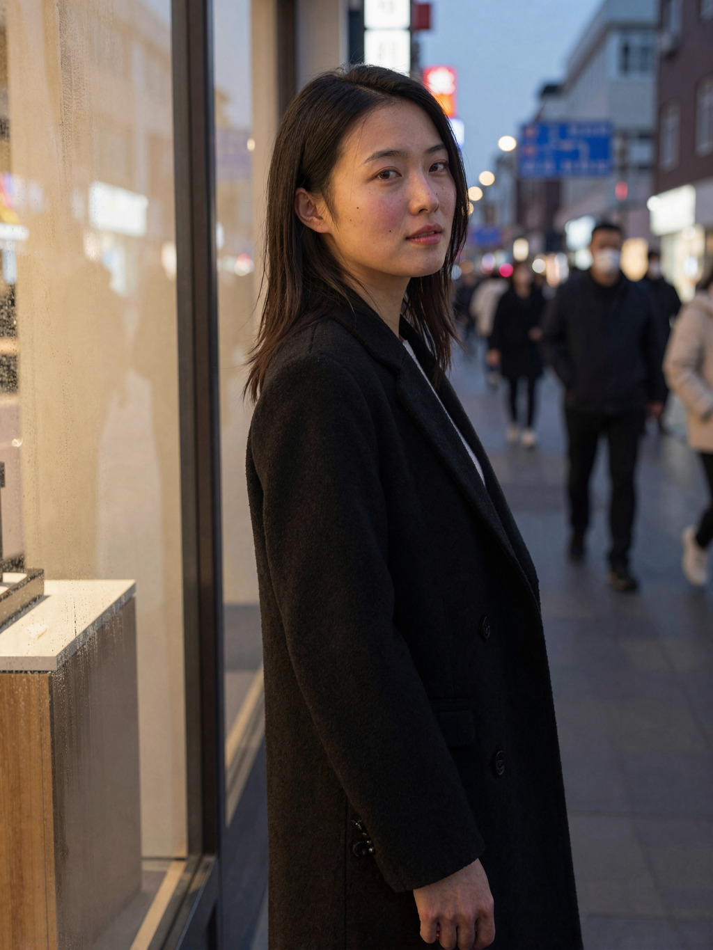 A quiet glance back beside the window at dusk