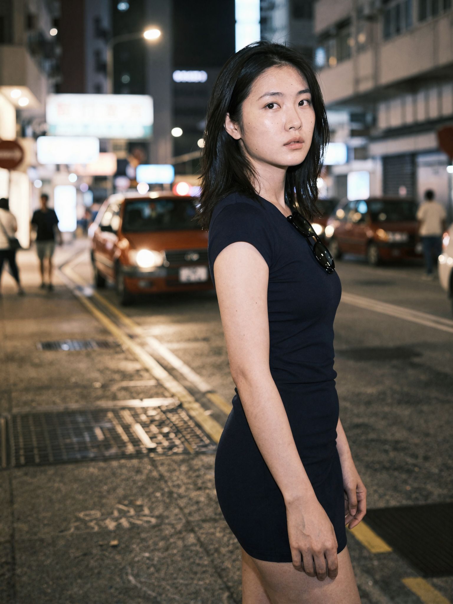 A quiet glance back on a bright city street